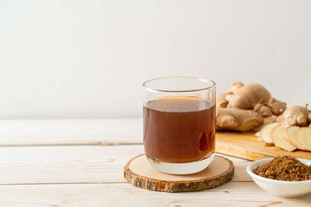 hot and sweet ginger juice glass with ginger roots - Healthy drink style