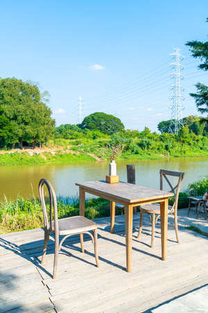 empty table and chair with river view and blue sky