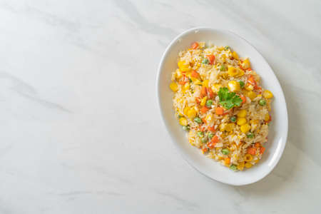 homemade fried rice with mixed vegetable (carrot, green bean peas, corn) and eggの写真素材