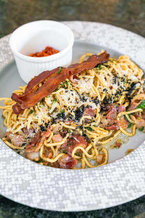 spaghetti aglio e olio with bacon - stir-fried spaghetti with garlic, olive oil, parsley, Parmigiano-Reggiano cheese tossed and baconの写真素材