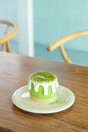 matcha green tea cheese cake on table in cafe restaurantの写真素材
