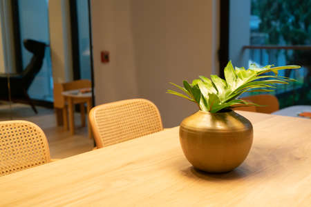 leaves in vase decoration on wood dining table