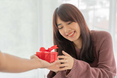 Asian women happy to receive a gift box or present