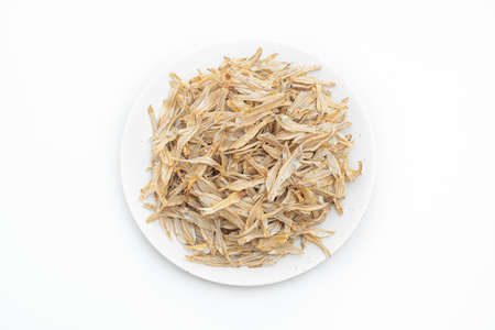 dried small crispy bake fish isolated on white backgroundの写真素材