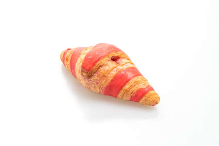 fresh croissant with strawberry jam sauce isolated on white backgroundの写真素材