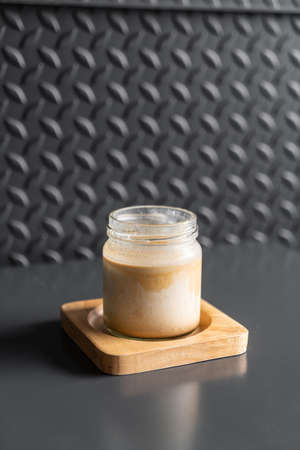 A glass of espresso shot over cold fresh milk create gradient layer called dirty coffee in coffee shopの写真素材