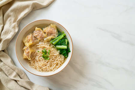 egg noodles with pork wonton soup or pork dumplings soup and vegetable - Asian food style