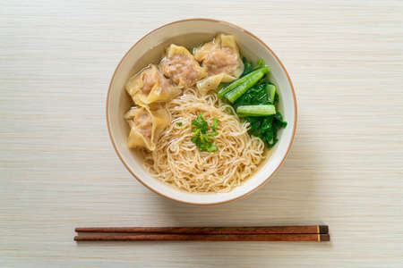 egg noodles with pork wonton soup or pork dumplings soup and vegetable - Asian food style