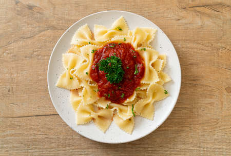 farfalle pasta in tomato sauce with parsley - Italian food style