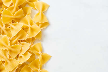 Dry uncooked farfalle pasta with copy spaceの写真素材
