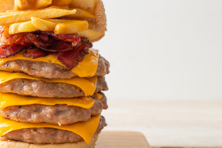 pork hamburger or pork burger with cheese, bacon and french friesの写真素材