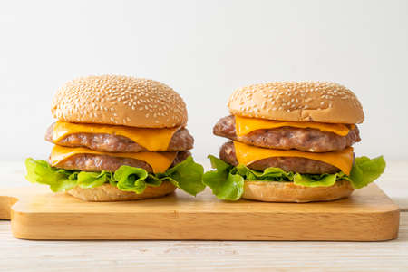 pork hamburger or pork burger with cheese on wooden board