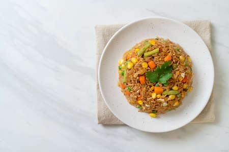 fried rice with green peas, carrot and corn - vegetarian and healthy food styleの写真素材