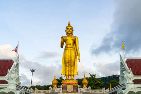 A golden buddha statue with sky on the mountain top at Hat Yai municipality public park, Songkhla Province, Thailandのeditorial素材