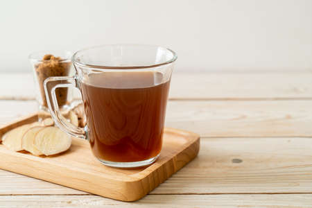 hot and sweet ginger juice glass with ginger roots - Healthy drink styleの写真素材