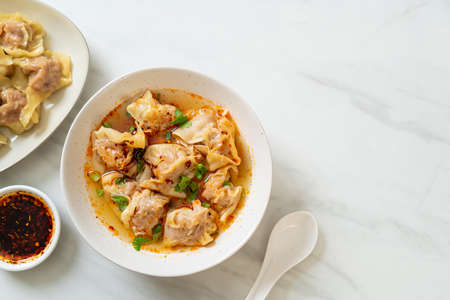 pork wonton soup or pork dumplings soup with roasted chili - Asian food styleの写真素材