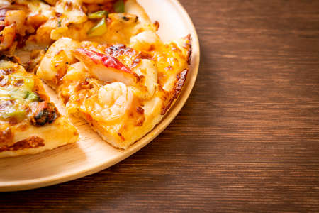 seafood (shrimps, octopus, mussel and crab) pizza on wood trayの写真素材