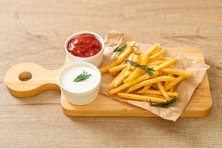 French fries or potato chips with sour cream and ketchupの写真素材