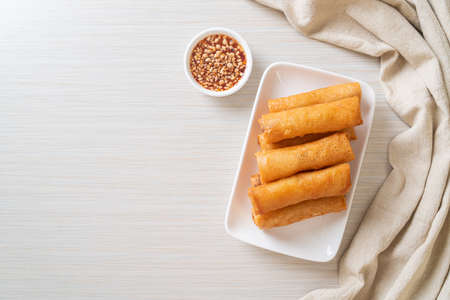 deep fried spring roll with sauce on white plate