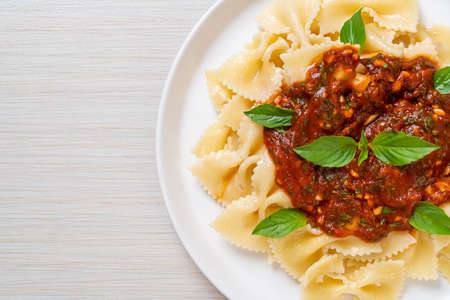 farfalle pasta with basil and garlic in tomato sauce - Italian sauce