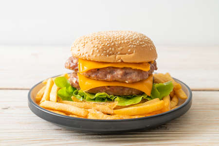 pork hamburger or pork burger with cheese and french fries