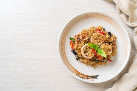 Homemade Basil and Spicy Herb Fried Rice with Squid or Octopus - Asian food styleの写真素材