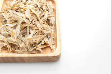 dried small crispy bake fish isolated on white backgroundの写真素材