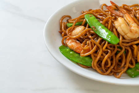 stir-fried yakisoba noodles with green peas and shrimps - Asian food styleの写真素材