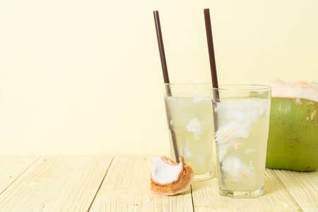 coconut water or coconut juice in glas with ice cubeの写真素材