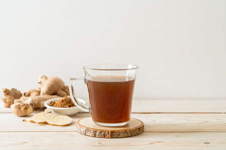 hot and sweet ginger juice glass with ginger roots - Healthy drink styleの写真素材