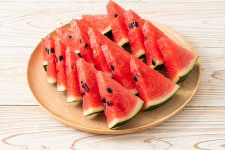 fresh watermelon sliced on wooden plateの写真素材