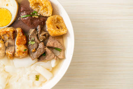 paste of rice flour or boiled Chinese pasta square with pork in clear soup - Asian food style