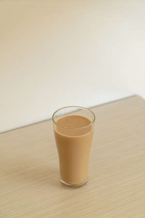 coffee latte glass with ready to drink coffee bottles on the tableの写真素材