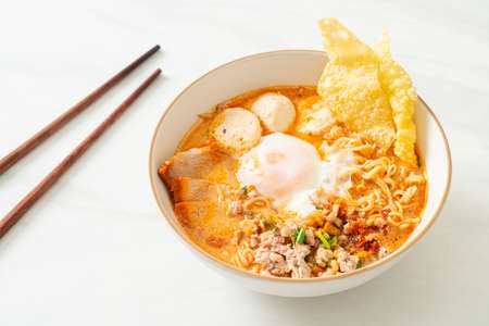 instant noodles with pork and meatballs in spicy soup or Tom Yum Noodles in Asian styleの写真素材