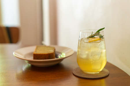 iced lemon honey glass with rosemary in cafe restaurant
