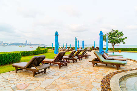 Chair pool or bed pool and umbrella around swimming pool