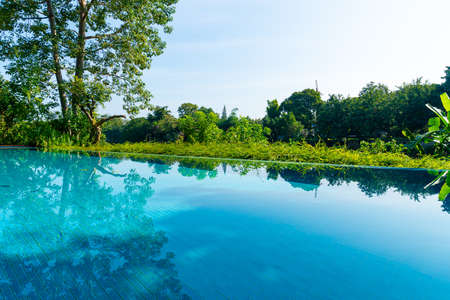 swimming pool in the garden with river viewの写真素材