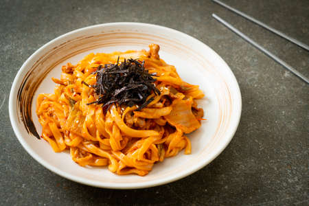 stir-fried udon noodles with kimchi and pork - Korean food styleの写真素材