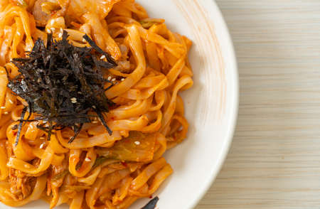 stir-fried udon noodles with kimchi and pork - Korean food styleの写真素材