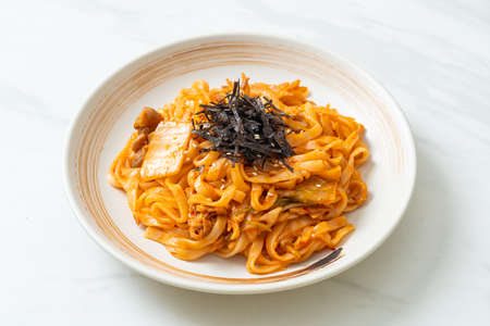 stir-fried udon noodles with kimchi and pork - Korean food styleの写真素材