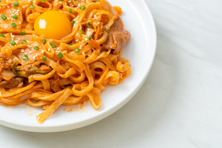 stir-fried udon noodles with kimchi and pork - Korean food styleの写真素材