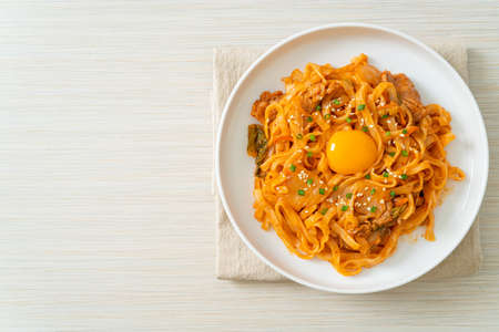 stir-fried udon noodles with kimchi and pork - Korean food style