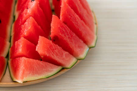 fresh watermelon sliced on wooden plateの写真素材
