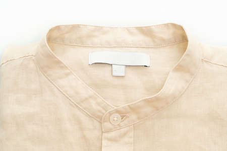 beige shirt fold isolated on white backgroundの写真素材