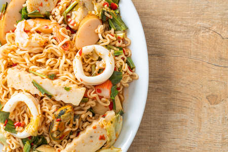 Instant noodle spicy salad with mixed meats - Asian food styleの写真素材