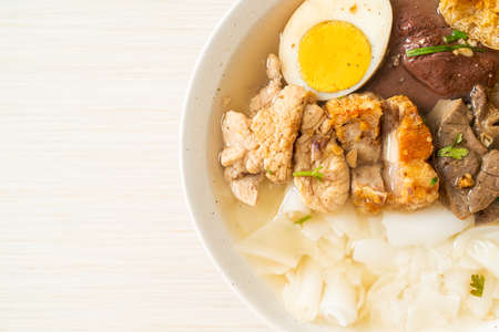 paste of rice flour or boiled Chinese pasta square with pork in clear soup - Asian food style