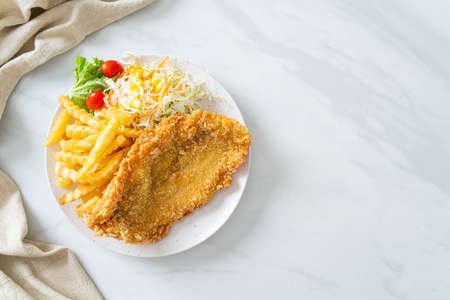 fried fish fillet and potatoes chips with mini saladの写真素材