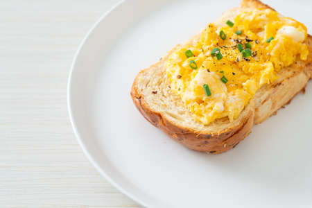 bread toast with scramble egg on white plate