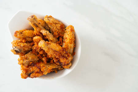 fried barbecue chicken wings in white bowl
