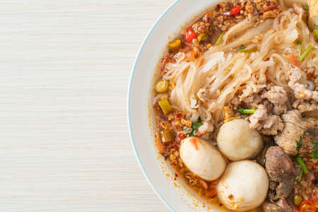noodles with pork and meatballs in spicy soup or Tom yum noodles in Asian style